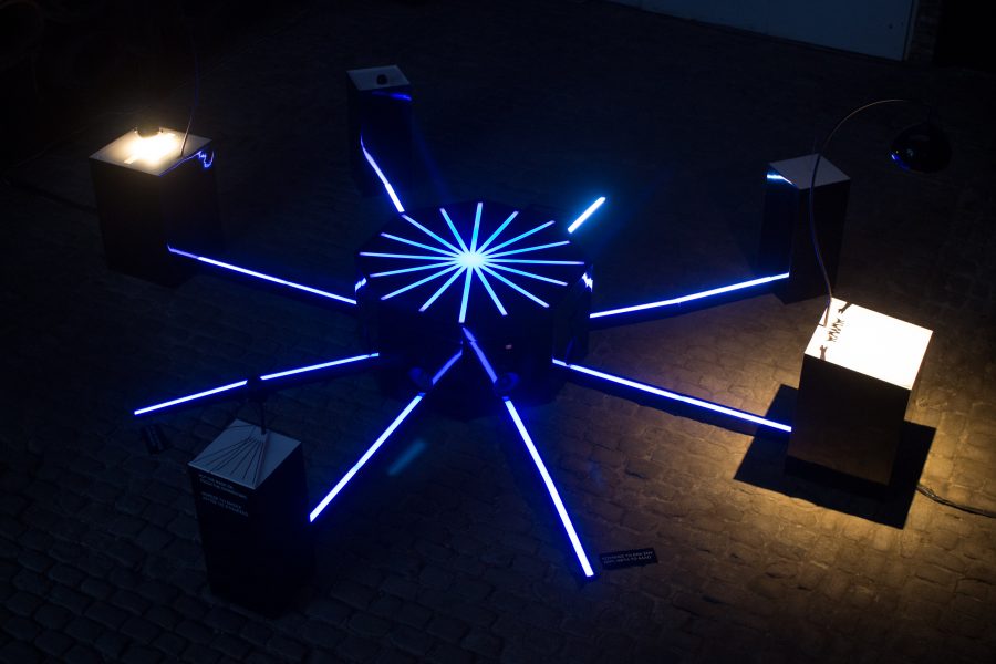 Blue spokes and a star-shaped hub illuminate the circular arrangement of instruments.